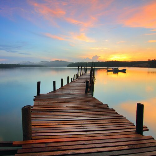 dock at sunrise leading to boat